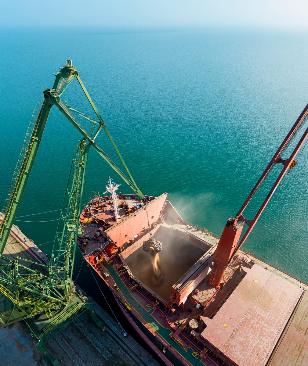 Ein Frachtschiff wird mit Getreide beladen