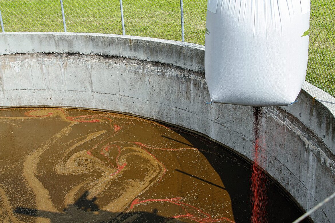 Ein Zusatzstoff wird in einen Güllebehälter gegeben